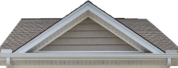 Front-facing gable roof of a beige house with white trim and brown asphalt shingles